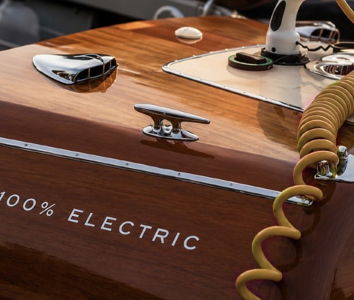 Electric tender with charging connector on its varnished wooden deck